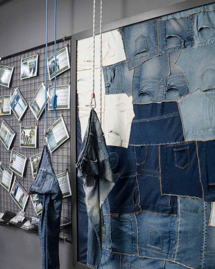 Denim wall of patchworked jeans panels beside a research pinboard